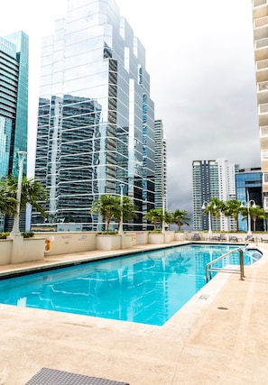 A swimming pool with a view of modern high-rise buildings. - Brickell 1BR / City Views / Balcony / FREE Parking / Pool / Hot Tub / Gym (Miami)