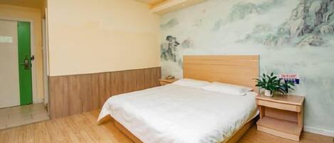A bedroom with a wooden bed, a nightstand with a plant, and a mural on the wall.
