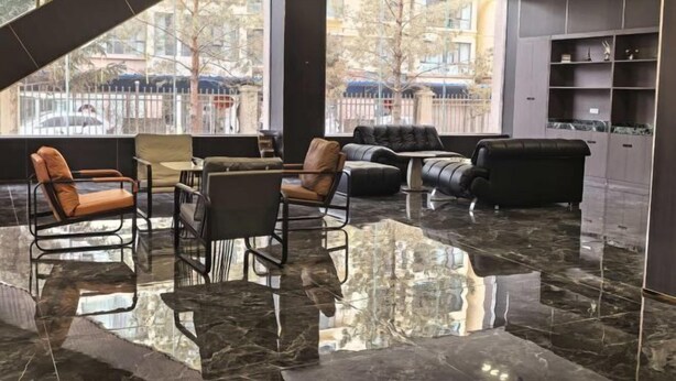 A modern lobby with a marble floor, leather seating, and large windows offering a view of the outside. - Zhangye Jiaheng International Hotel (Municipal Government & Big Buddha Temple Branch) (Zhangye)