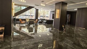 A modern lobby with a marble floor, seating area, and a staircase leading to upper floors. - Zhangye Jiaheng International Hotel (Municipal Government & Big Buddha Temple Branch) (Zhangye)