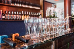 A bar with a row of empty glasses on a counter.
