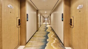 A hotel hallway with wooden doors, a long corridor, and a unique floor design. - Friend Yue Hotel (Zhangjiajie Town Centre Huilong Road) (Zhangjiajie)
