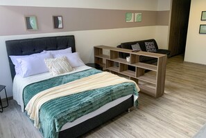 Relax in this inviting space with a comfortable bed, a cozy seating area, and a convenient nightstand.