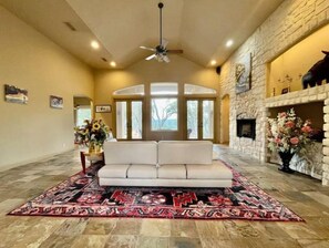 Relax in this inviting living area with a sofa, fireplace, and large window.
