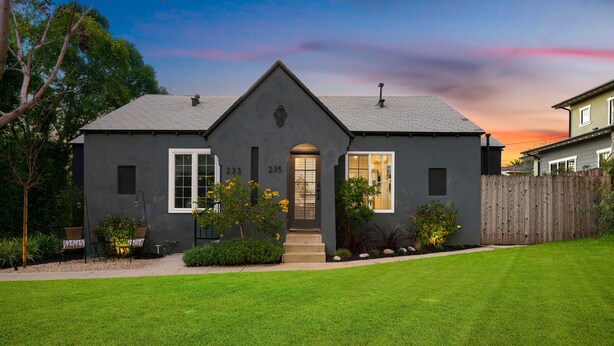 A two-story house with a grey exterior, a front porch, and a well-maintained lawn. - Designer Digs (Monrovia)