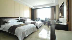 A hotel room with two beds, a desk, a chair, and a large window. - Kai Bin Hotel (Baiyin)