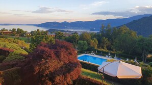 A pool with a view of a lake and mountains.