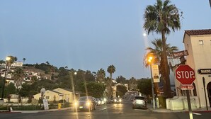 A street view at dusk with a stop sign, a marine sign, and a building labeled "Harvey". - San Diego Old Town Family-sized Apartment with Patio (San Diego)