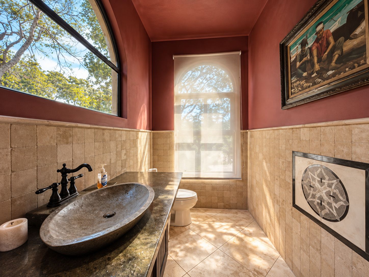 A bathroom with a large window, a sink, and a toilet.