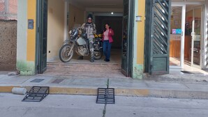 A building with a motorcycle parked at the entrance, a person standing nearby, and a visible door number 272. - Mariterra Host (Puerto Inca)