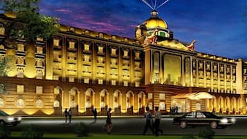 A large, multi-story hotel with a prominent dome and arched windows.