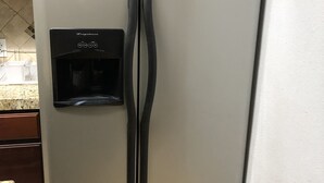 A stainless steel refrigerator with a water dispenser and a freezer compartment. - Farmhouse retreat (Tulare)