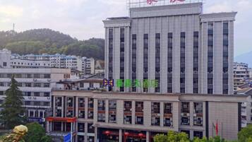 A multi-story building with a prominent entrance and signage.
