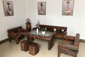 A traditional wooden furniture set including a sofa, a coffee table, and a bench. - Dongxing Jinghui Hotel (Dongxing)