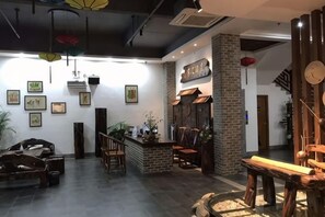 Un intérieur moderne avec un bar, des sièges et des œuvres d’art accrochées aux murs.