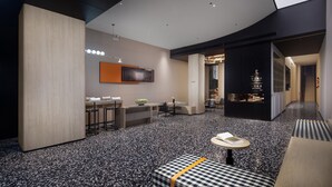 A modern hotel lobby with a bar area, seating, and a reception desk. - SPEY HOTEL (Guangzhou)