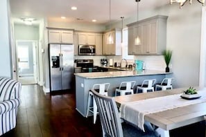 Enjoy cooking in this well-equipped kitchen with a central island, oven, and microwave.