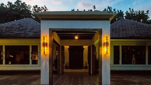 A building entrance with a covered walkway, two side windows, and a central light fixture.