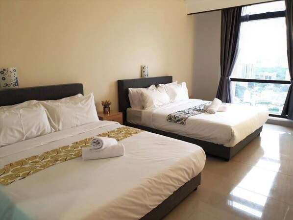 A hotel room with two beds, a large window with a city view, and a clean, modern design.