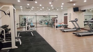 A gym with treadmills, weight machines, and a mirror wall. - KL TIMES SQUARE SERVICE RESIDENCIES  (Kuala Lumpur)