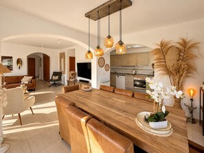A modern living space with a dining area, kitchen, and seating arrangements. - Holiday house  with private pool in Calonge, Catalonia, Spain for 6 persons (Calonge)