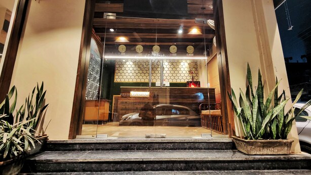 A hotel entrance with a reception desk, a clock, and a sign indicating a reception area. - Hotel 21 Chandigarh (Chandigarh)