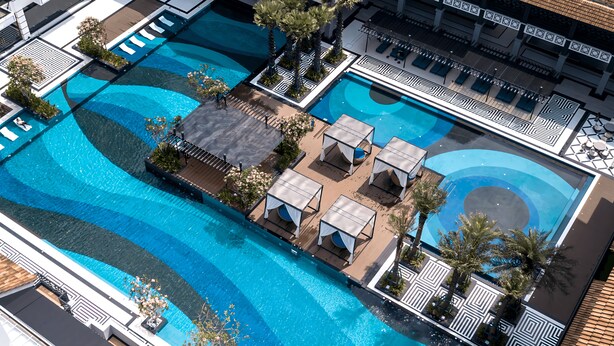 An aerial view of a hotel with multiple swimming pools, sun loungers, and palm trees. - Bertam Resort and Water Park Penang (Kepala Batas)