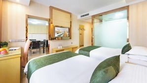A hotel room with two beds, a desk, a chair, a mirror, and a view of the interior. - GreenTree Shell Hotel (Yiwu International Business City Changchun Accessories Specialty Street) (Yiwu)