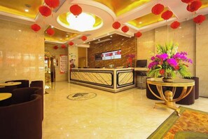 A hotel lobby with a reception desk, seating area, and decorative elements like red lanterns. - GreenTree Shell Hotel (Yiwu International Business City Changchun Accessories Specialty Street) (Yiwu)