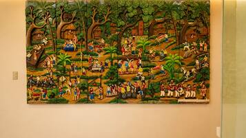 A large mural depicting a vibrant, detailed scene with various figures and activities.
