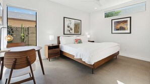 A modern bedroom with a bed, bedside tables, a desk, and chairs. - SPCH07 - Eco-friendly Studio Container - 80 Walkscore! (Phoenix)