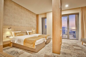 A hotel room with a large bed, two bedside tables, a wooden headboard, a large window with curtains, and a view of the cityscape. - Ameri Plaza, Tbilisi (Tbilisi)