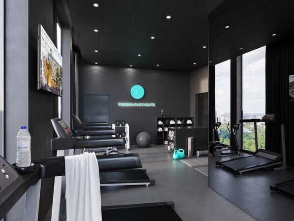 A modern gym with treadmills, weights, and exercise balls. - VISIONAPARTMENTS Glattbrugg (Opfikon)