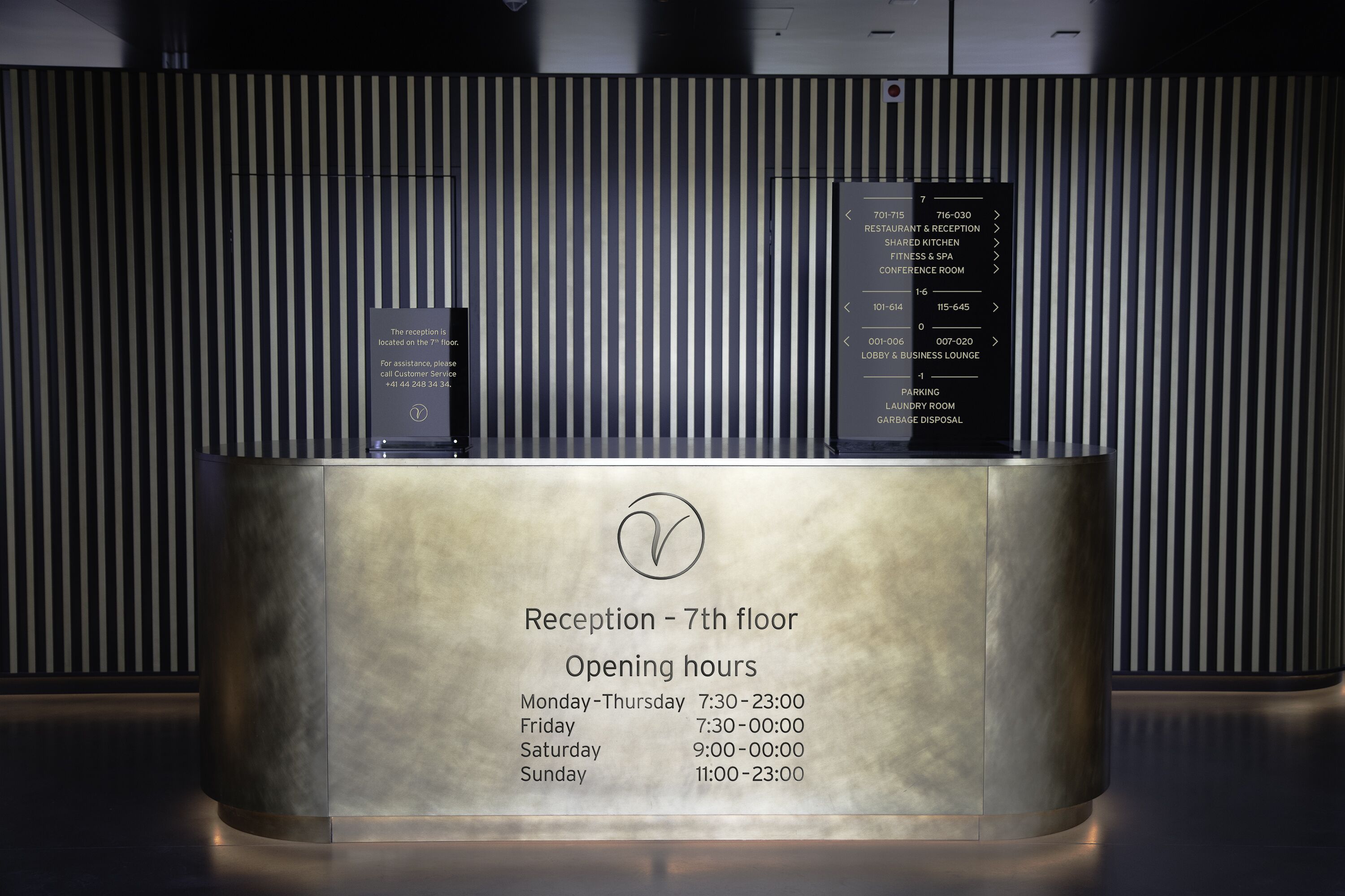 A reception desk on the 7th floor with opening hours listed: Mon-Thu 7:30-23:00, Fri 7:30-00:00, Sat 9:00-00:00, Sun 11:00-23:00.