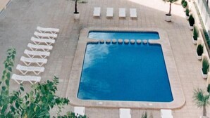 A swimming pool with lounge chairs and potted plants around it. - Biarritz Apartments (Gandia)