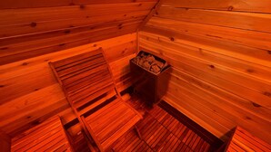 A wooden interior with a sloped ceiling, a bench, and a trash bin. - The Jewel: Spacious 3 Bdrm Victorian Apt w/ Sauna, Parking. Just 10 mins To NYC! (Jersey City)