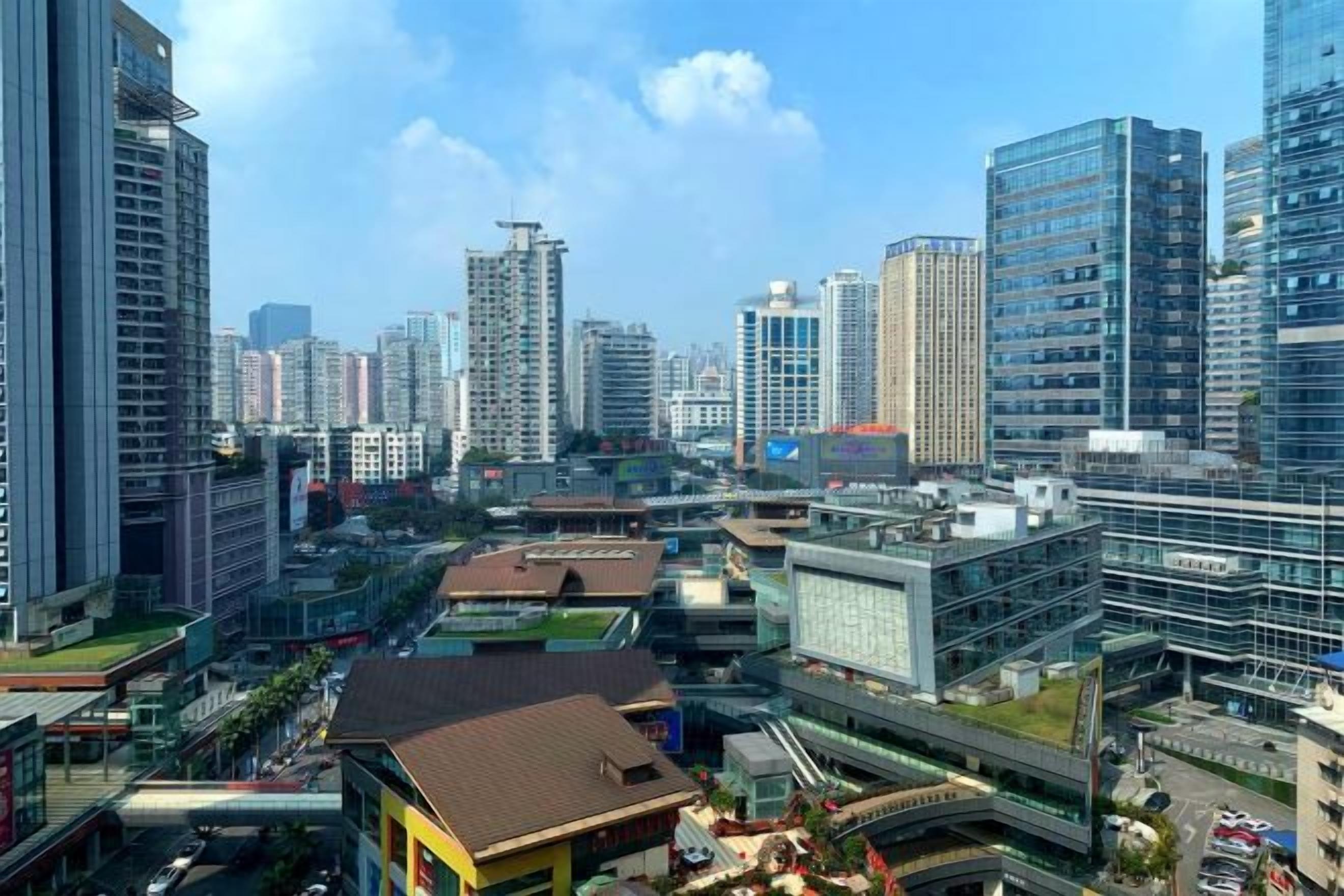 A cityscape with high-rise buildings, a bridge, and a mix of commercial and residential structures.