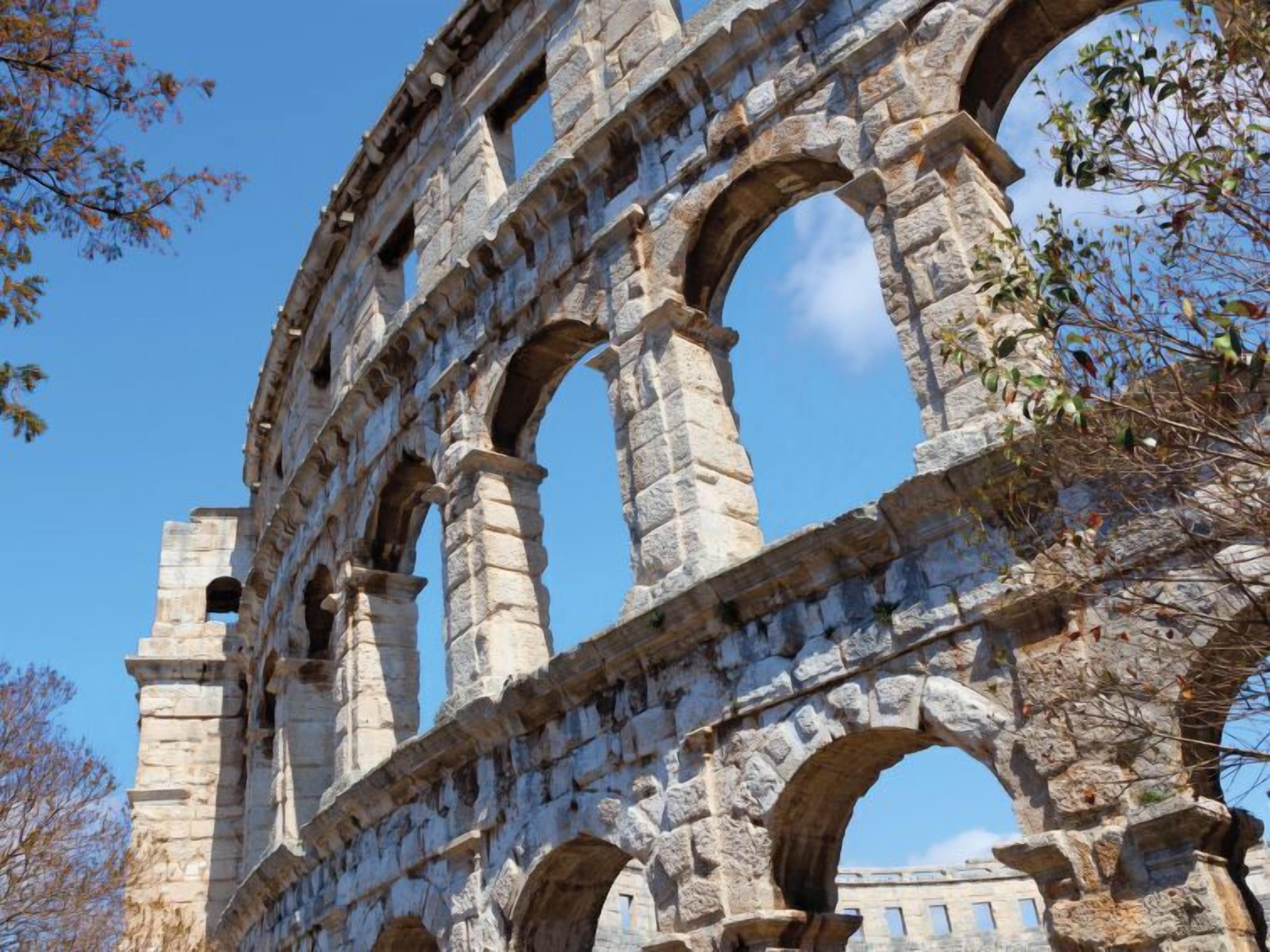 A stone aqueduct with multiple arches, part of an ancient structure.