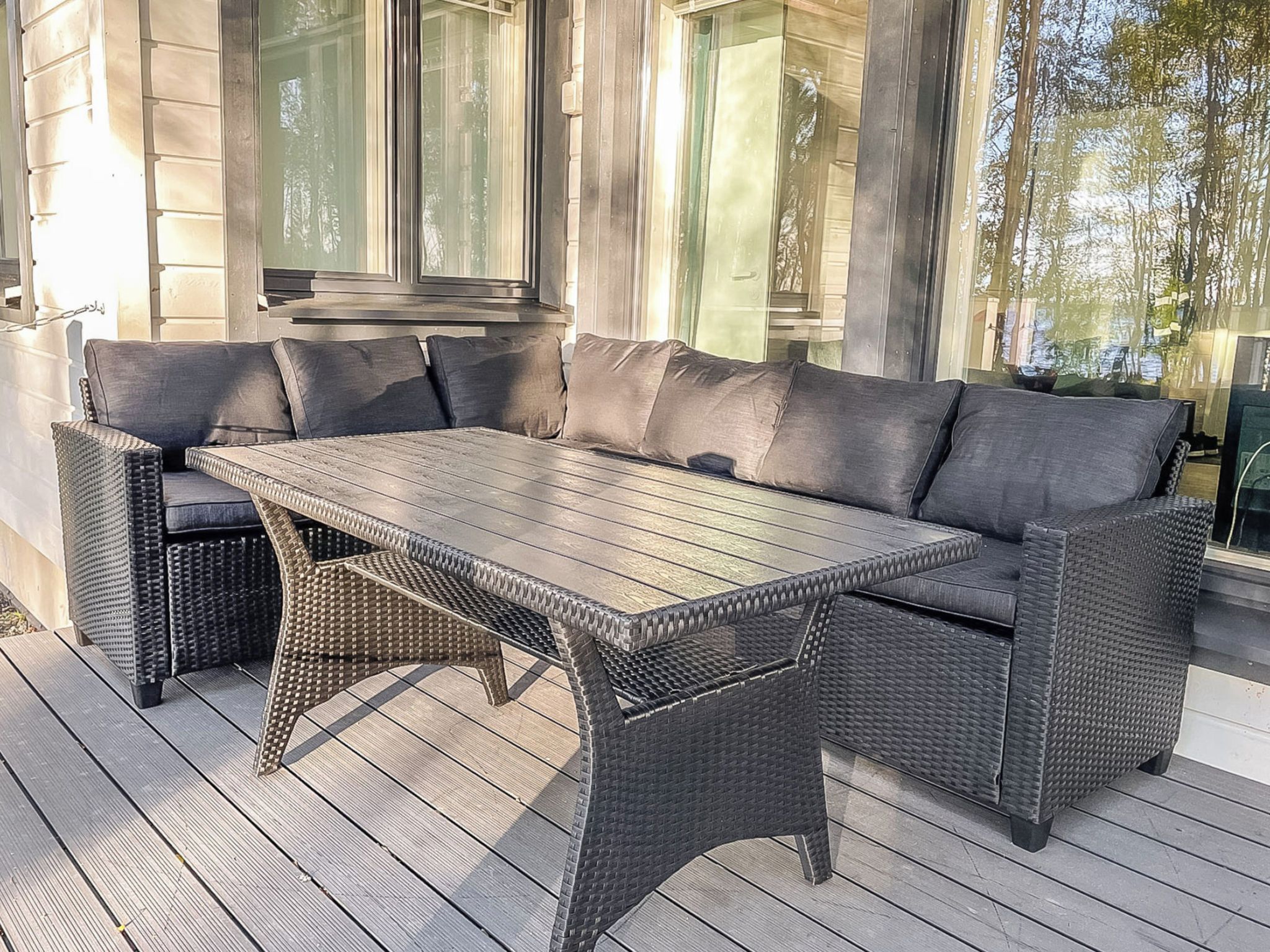 A wicker outdoor seating area with a table and chairs.