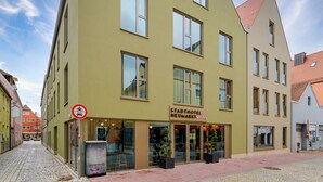 A hotel with a sign reading "Stadthotel Neumark Mitte" on a street corner. - Stadthotel Neumarkt Mitte (Neumarkt in der Oberpfalz)