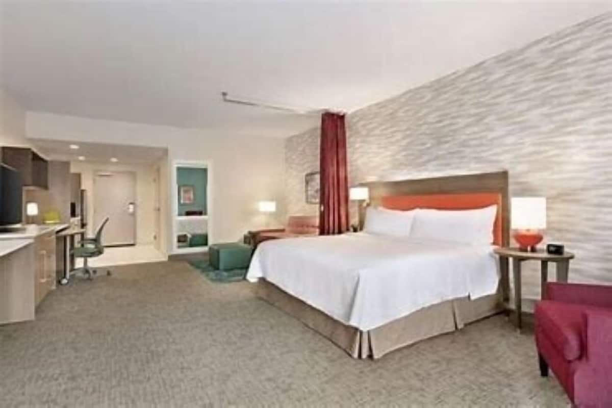 Desk, laptop workspace, iron/ironing board, bed sheets