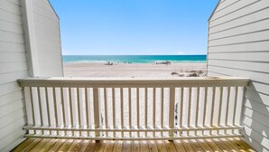 A wooden deck with a view of a beach and ocean. - Very Merry - Renovated Gulf-Front Escape, Steps To Beach (Panama City Beach)