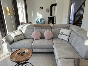 A modern living room with a grey sectional sofa, a wooden coffee table, and decorative pillows.