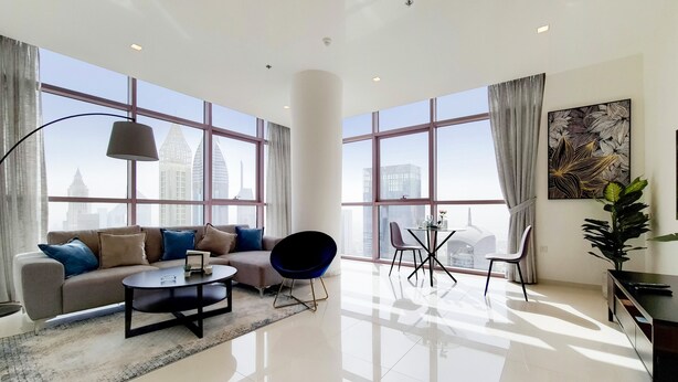 A modern living room with a sofa, coffee table, and chairs, large windows with curtains, and a city view. - GreenFuture - Panoramic City View From This High-Rise Chic Condo (Dubai)