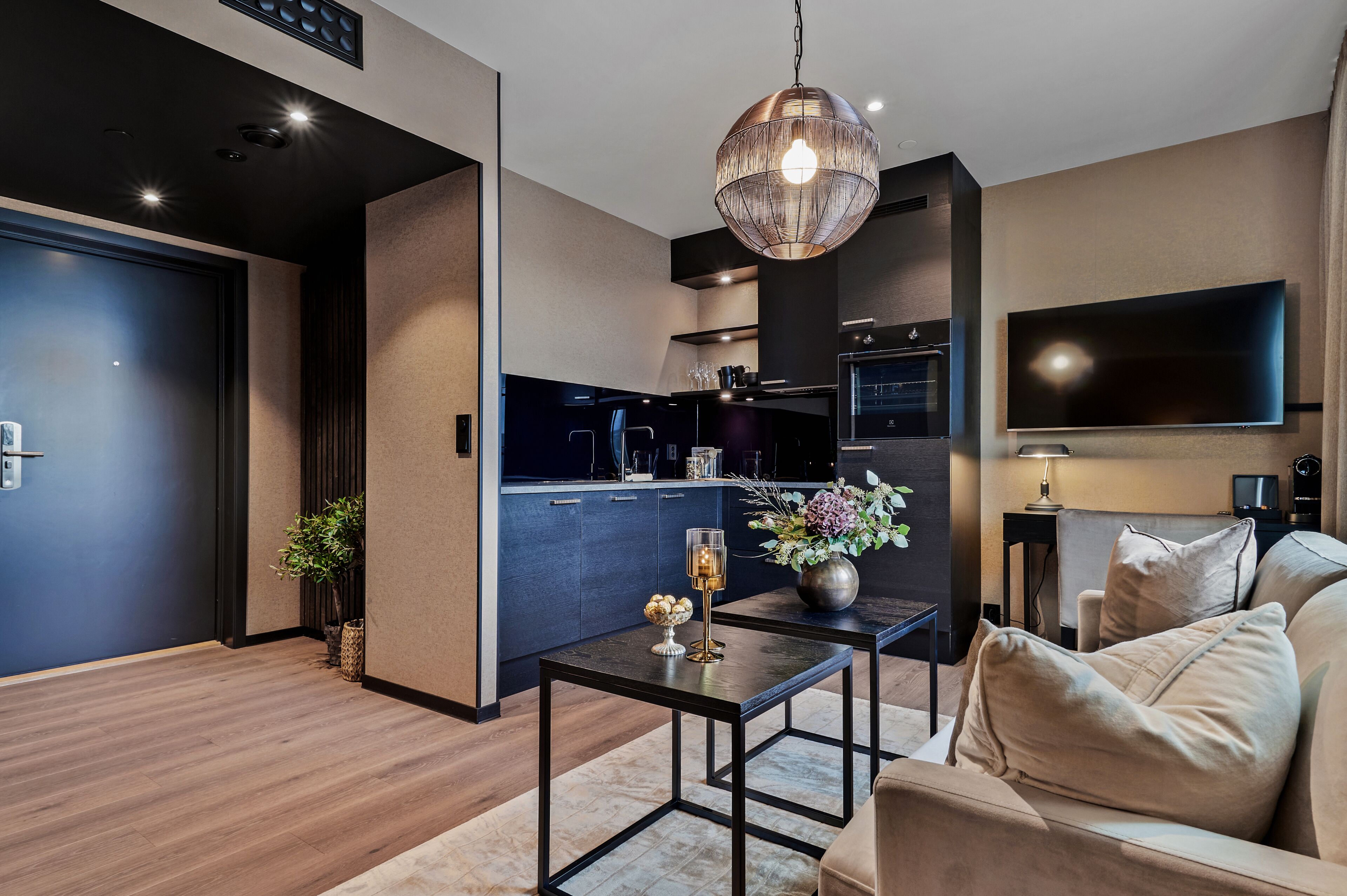 A modern living room with a sofa, a coffee table, and a TV.