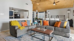 A living room with a gray sofa, a coffee table, and a ceiling fan.