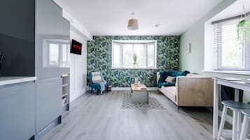 Apartment, 1 King Bed with Sofa bed, Non Smoking | Living area | 43-inch LCD TV with satellite channels, TV