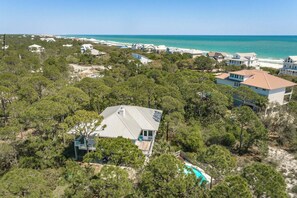 A coastal residential area with houses, a swimming pool, and a view of the ocean. - Welcome to Shooting Star! (St. George Island)
