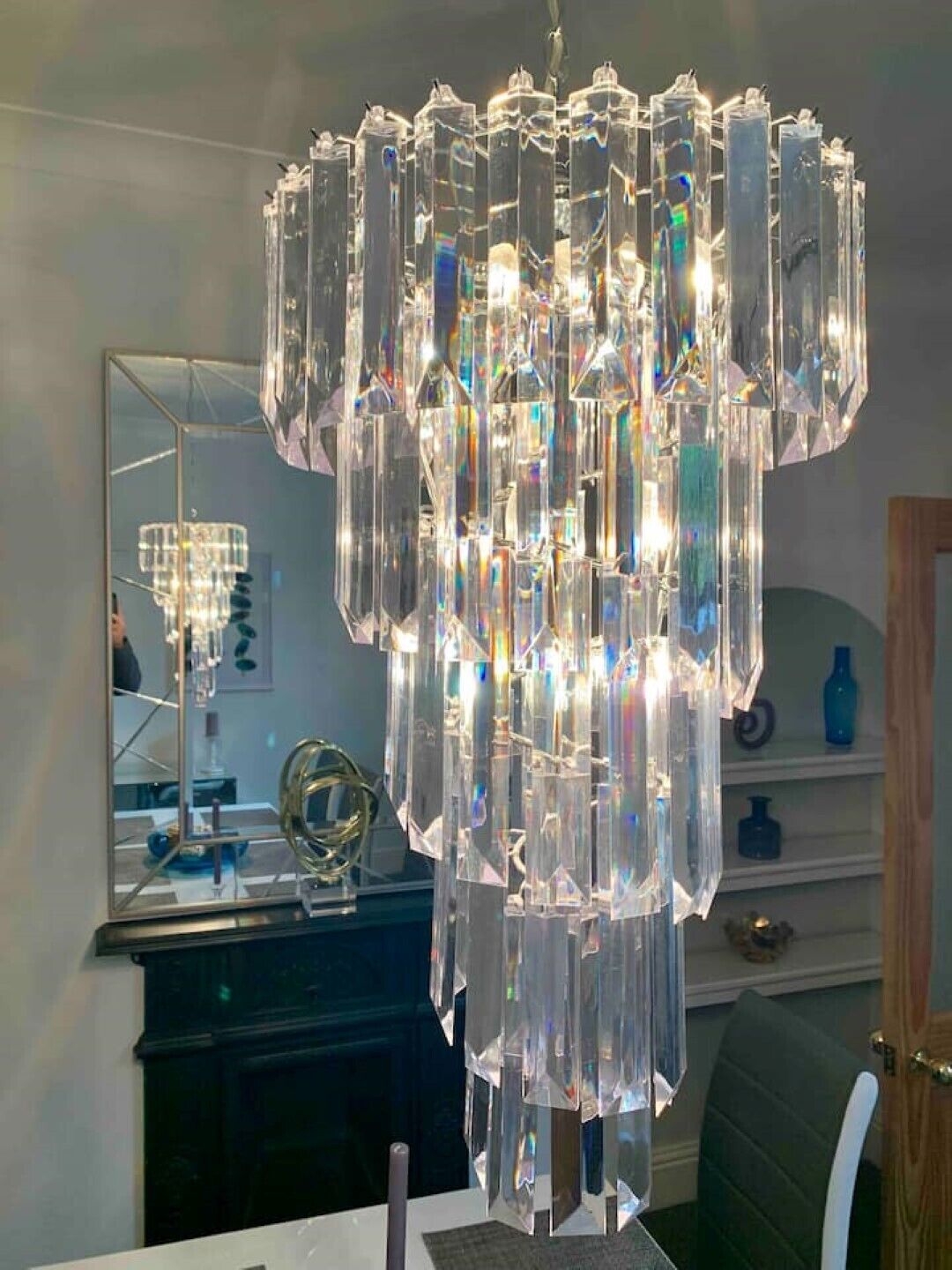 A chandelier with multiple crystal elements hanging from the ceiling.