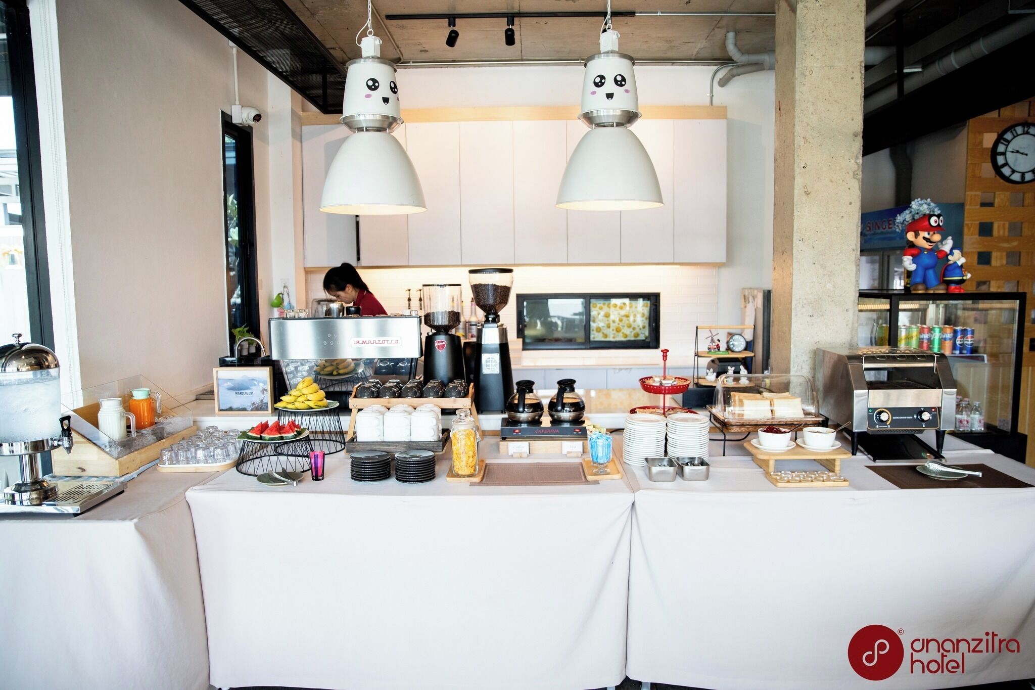 A breakfast buffet setup with various food items and a coffee machine.